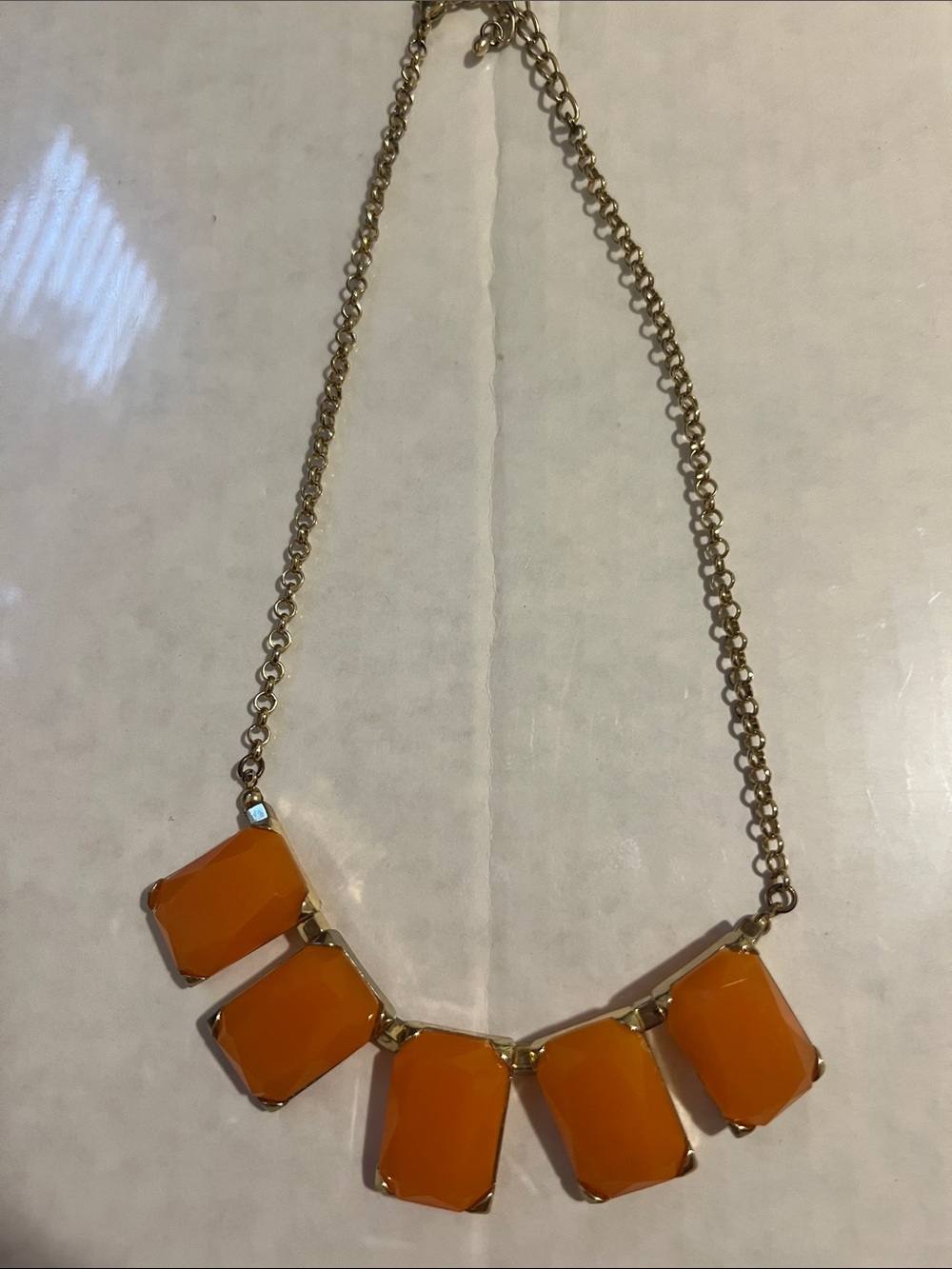 Statement necklace with five orange rectangles